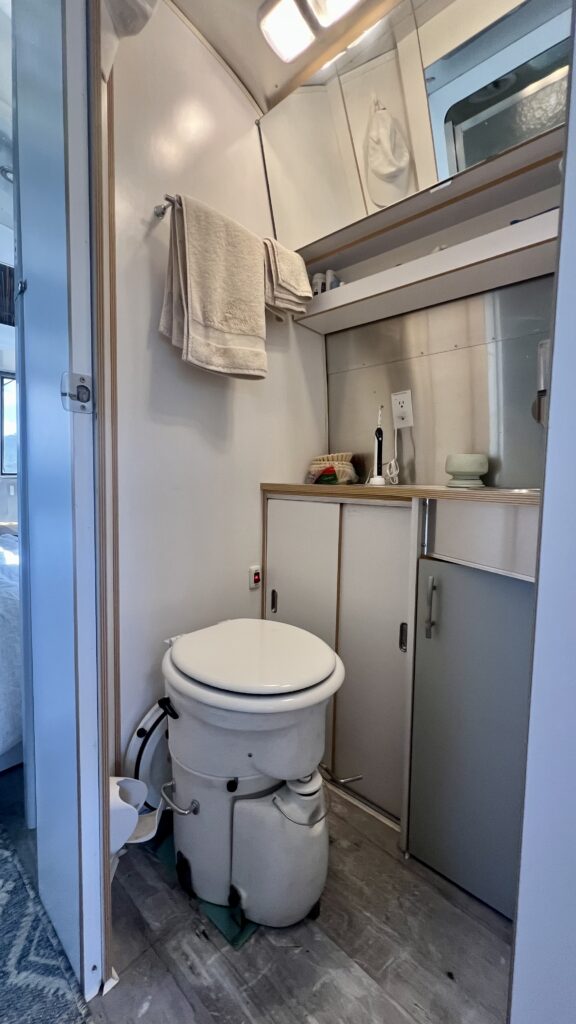 Bathroom with an AirHead toilet in an Airstream